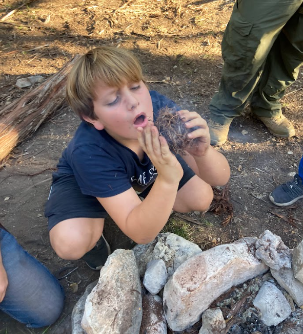 Jackson starts the campfire 