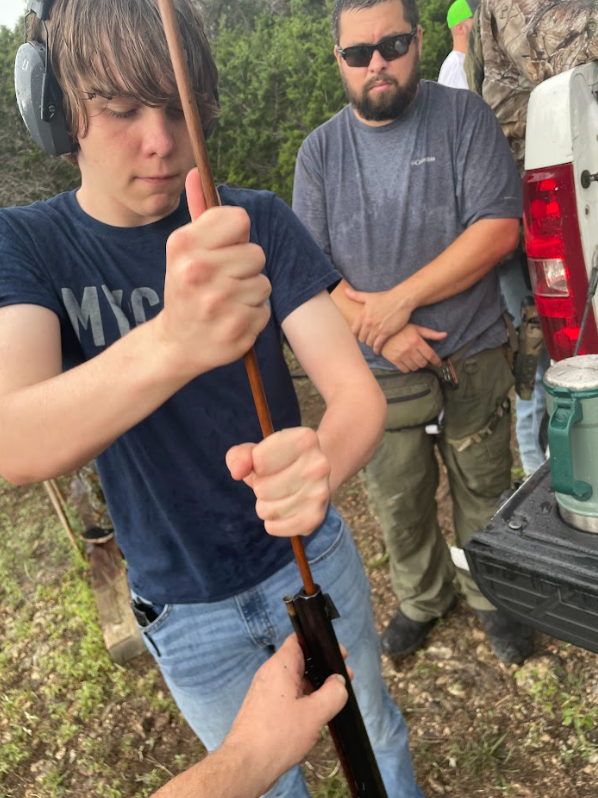 Josiah loads the Hawken while Carlos keeps an eye on safety 